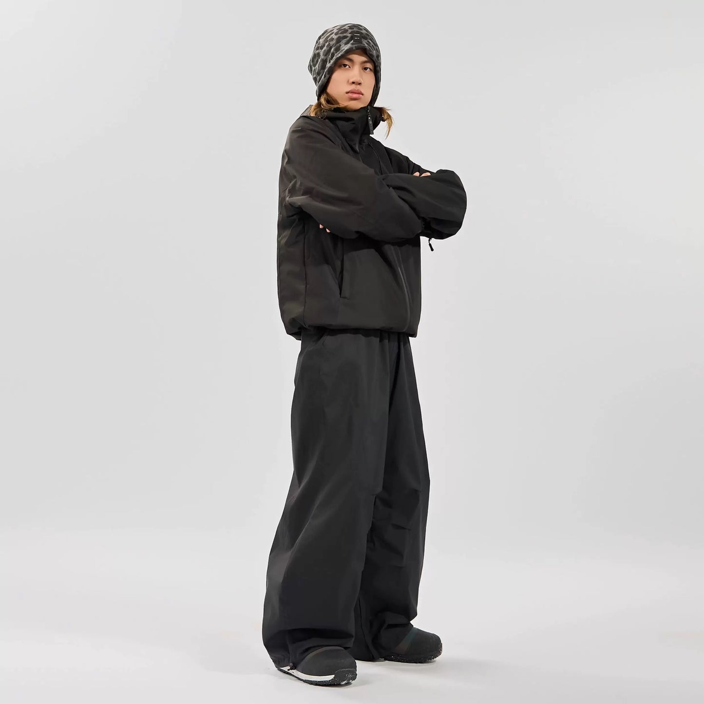Person wearing a black snowsuit on a white background