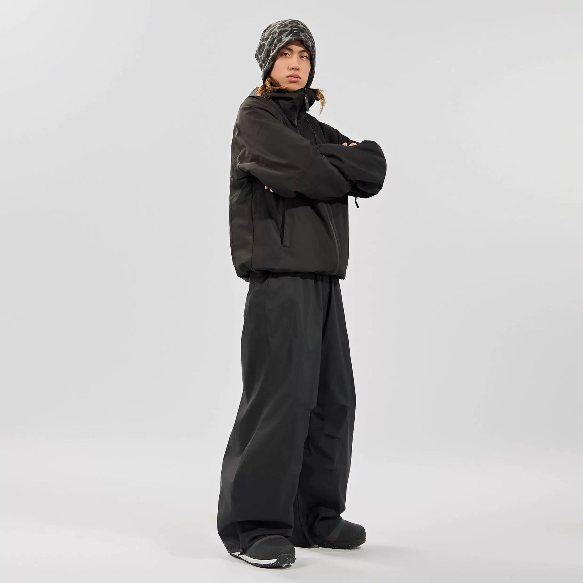 Person wearing a black snowsuit on a white background