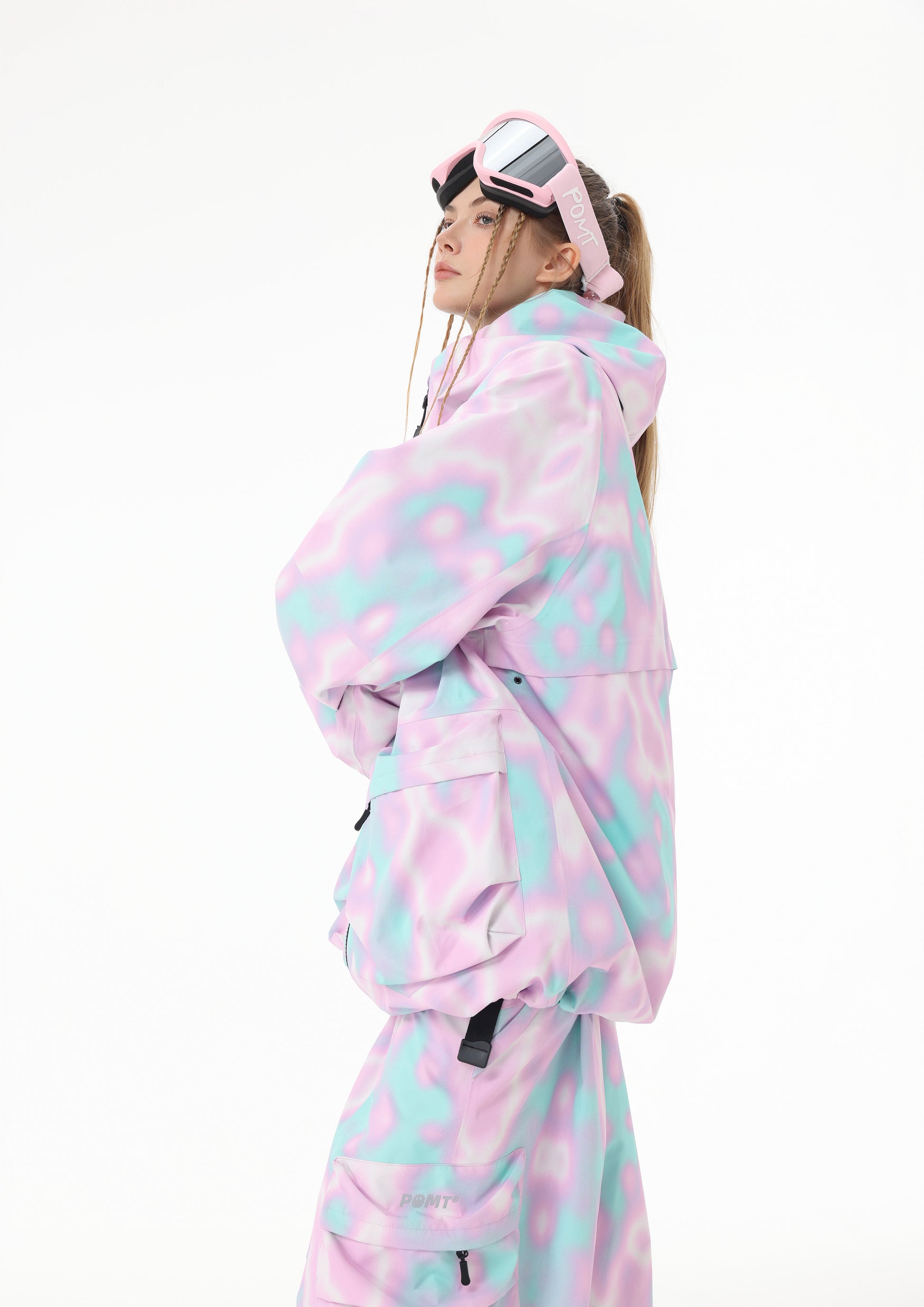 Person wearing a pastel tie-dye snowsuit on a white background